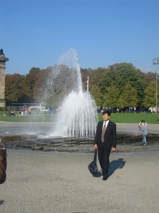 Japanese businessman in front of beautiful fountain