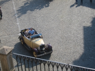 A tourist couple touring in an antique car