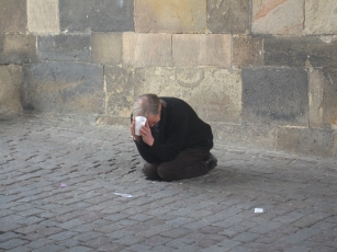 A beggar was kneeling under the tower